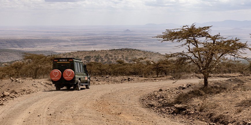 Fyrhjulsdrivet fordon med TourCompass-logotyp på safari i Tanzania
